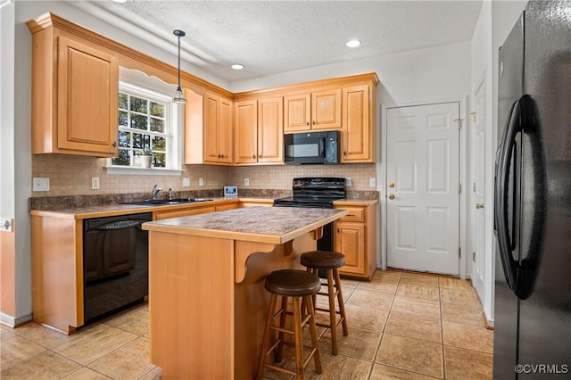 kitchen featuring a sink, tasteful backsplash, black appliances, a kitchen island, and light tile patterned floors