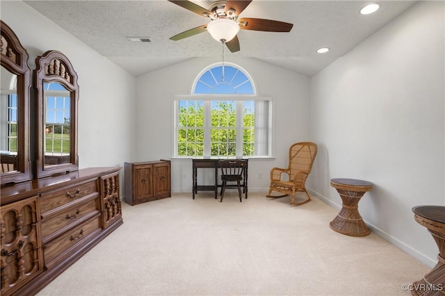 office area featuring baseboards, visible vents, carpet, lofted ceiling, and ceiling fan