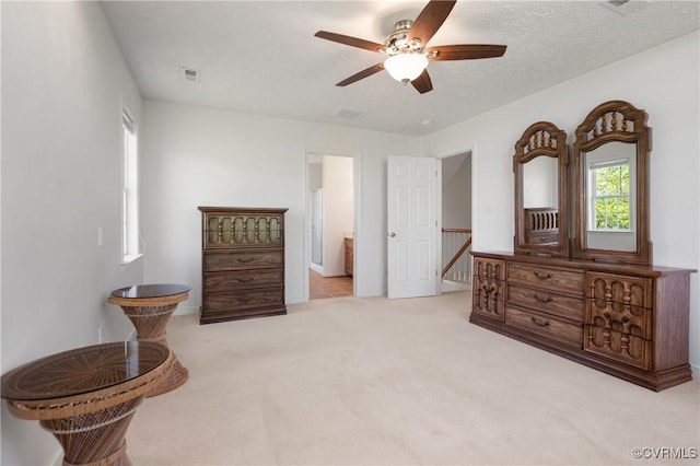 bedroom with visible vents, a ceiling fan, carpet flooring, and ensuite bath