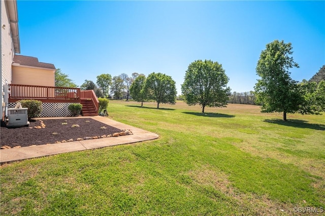 view of yard featuring a wooden deck and cooling unit