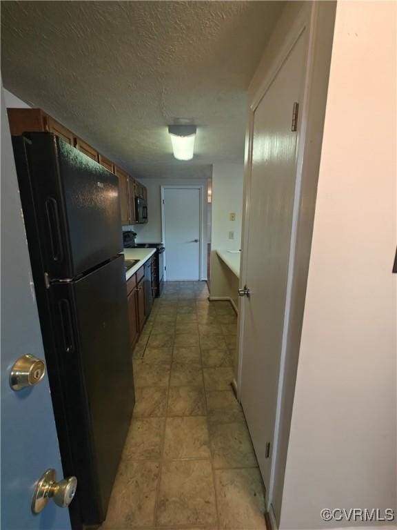 hallway featuring a textured ceiling