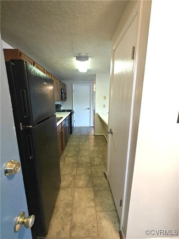 7701 Okeith Ct Unit 1601, Henrico, VA 23228 - kitchen featuring black appliances, light countertops, and a textured ceiling