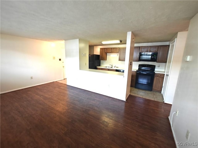 7701 Okeith Ct Unit 1601, Henrico, VA 23228 - kitchen with black appliances, light wood-type flooring, a textured ceiling, light countertops, and open floor plan