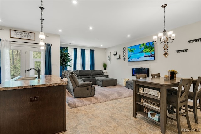 living area with recessed lighting and a chandelier