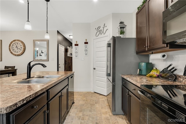 kitchen with baseboards, a sink, dark brown cabinetry, black appliances, and pendant lighting