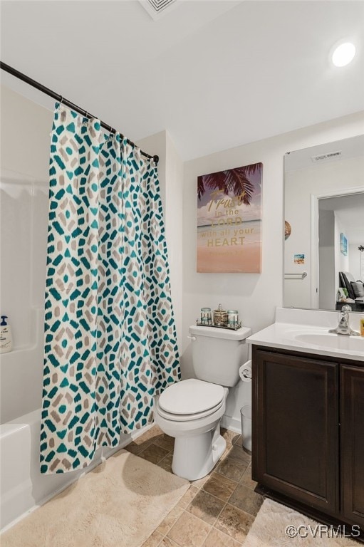 bathroom with stone finish floor, vanity, visible vents, toilet, and shower / bath combo with shower curtain