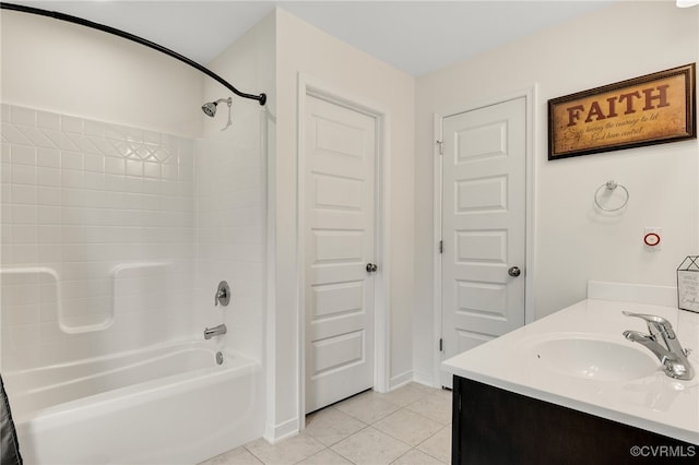 bathroom featuring baseboards, a sink, double vanity, shower / bathtub combination, and tile patterned flooring