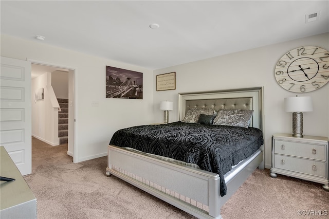 carpeted bedroom with visible vents and baseboards