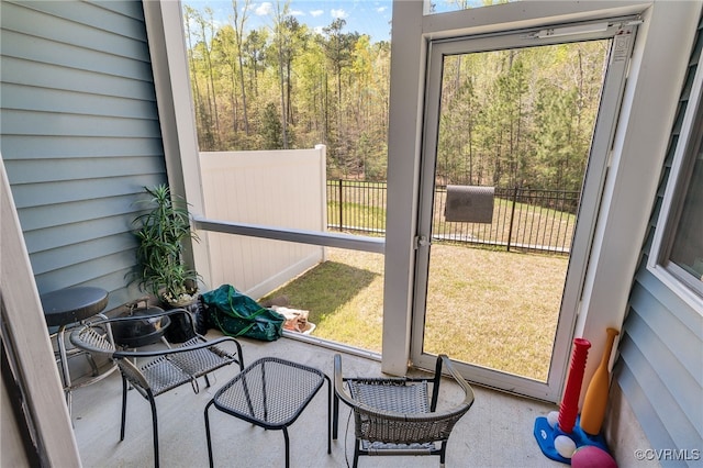 sunroom / solarium featuring a forest view