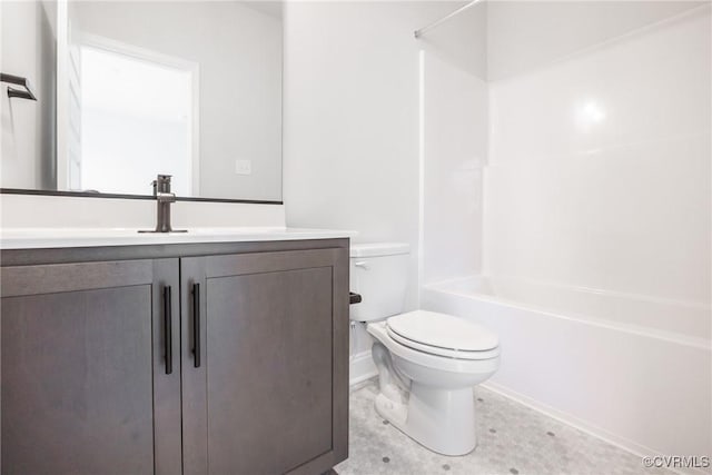 bathroom with vanity, toilet, baseboards, and shower / bath combination