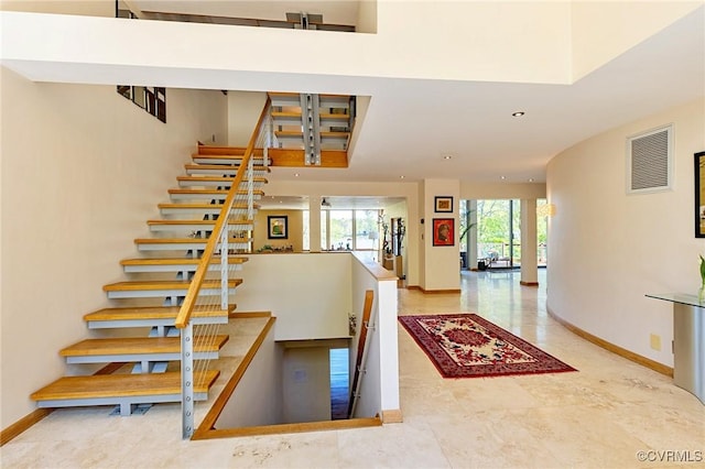 stairs with recessed lighting, baseboards, and visible vents