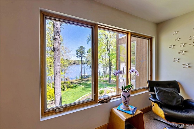 interior space featuring baseboards and a water view