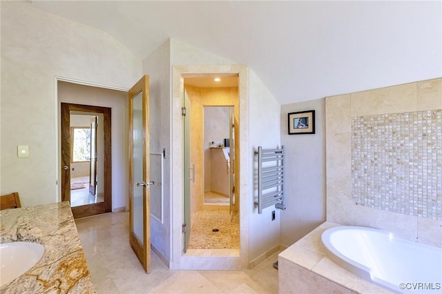 bathroom featuring a garden tub, tile patterned flooring, vanity, radiator heating unit, and a stall shower