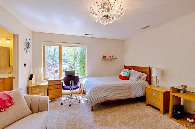 bedroom featuring ensuite bathroom, light carpet, a notable chandelier, and visible vents