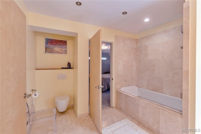 bathroom with toilet, tile patterned floors, a relaxing tiled tub, and a tile shower