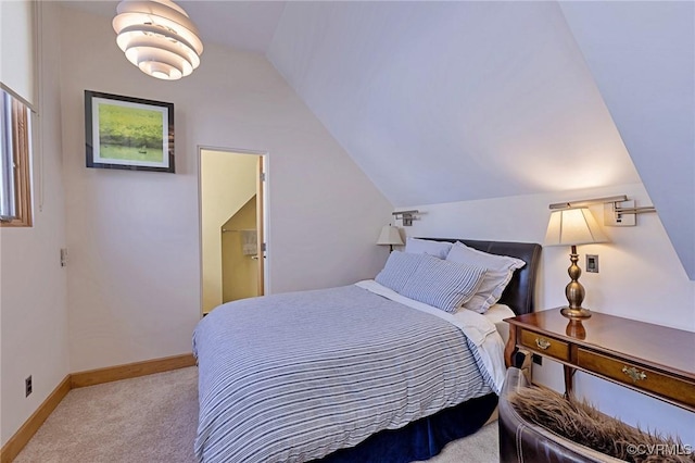 carpeted bedroom with baseboards and vaulted ceiling