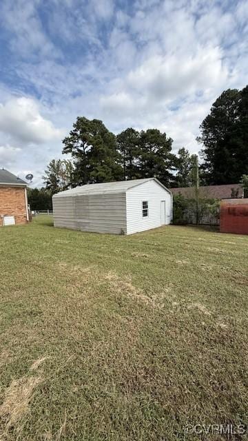 view of yard featuring a storage unit and an outbuilding