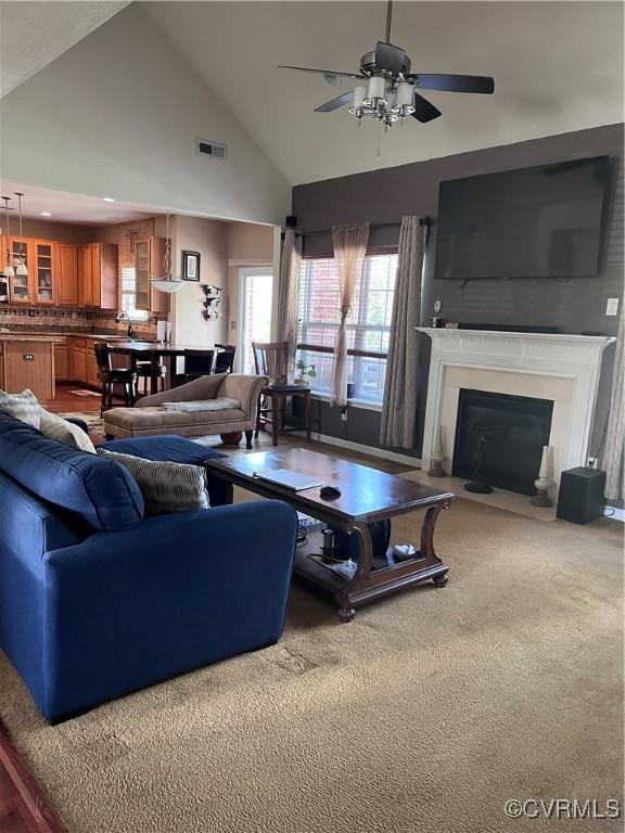 502 Peafowl Ct, Suffolk, VA 23435 - living room with a ceiling fan, carpet floors, a fireplace with flush hearth, and high vaulted ceiling