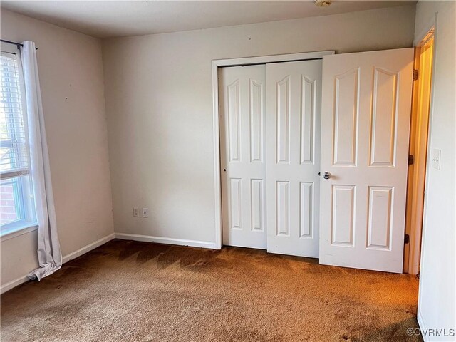 502 Peafowl Ct, Suffolk, VA 23435 - unfurnished bedroom with carpet, a closet, and baseboards