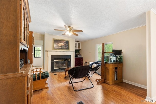 10340 Swift Rd, Partlow, VA 22534 - living room with a fireplace, wood-type flooring, a ceiling fan, a textured ceiling, and baseboards