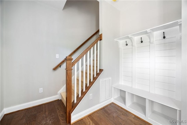 mudroom featuring visible vents, baseboards, and wood finished floors
