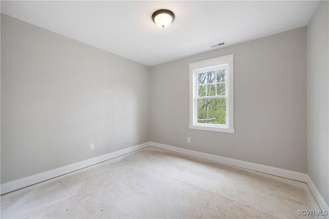 empty room with visible vents, baseboards, and unfinished concrete flooring