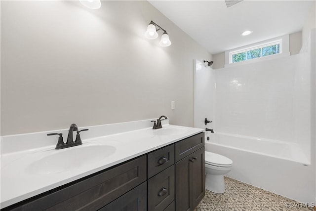 full bath with double vanity,  shower combination, a sink, and toilet