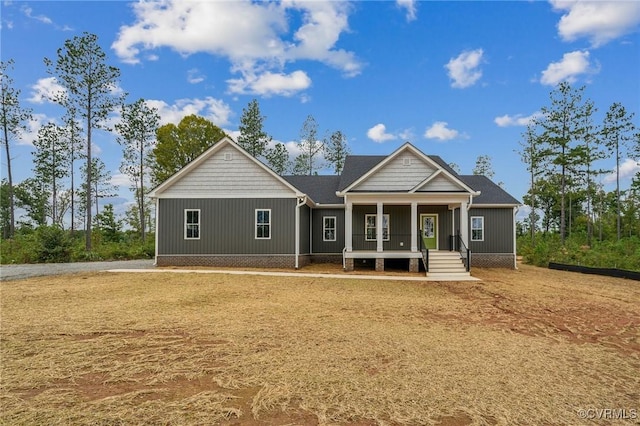 back of house with board and batten siding and a porch