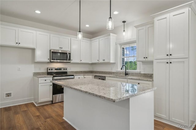kitchen with stainless steel appliances, dark wood-style floors, white cabinetry, and a sink