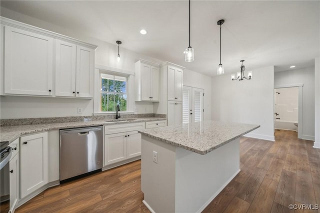 kitchen featuring stainless steel dishwasher, recessed lighting, white cabinets, and a sink