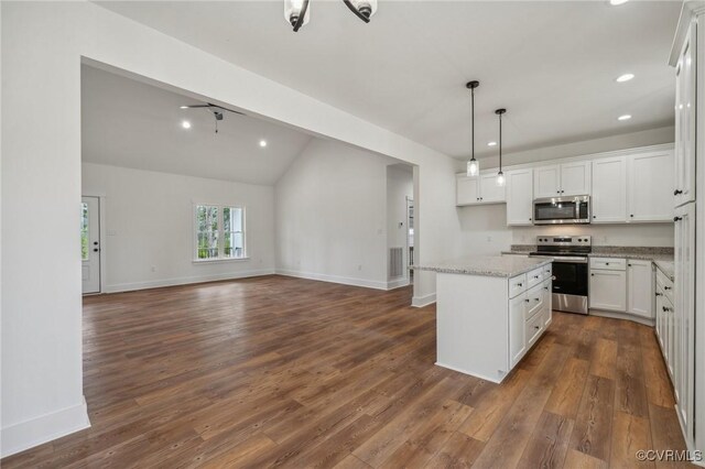 kitchen with white cabinetry, recessed lighting, a kitchen island, stainless steel appliances, and open floor plan