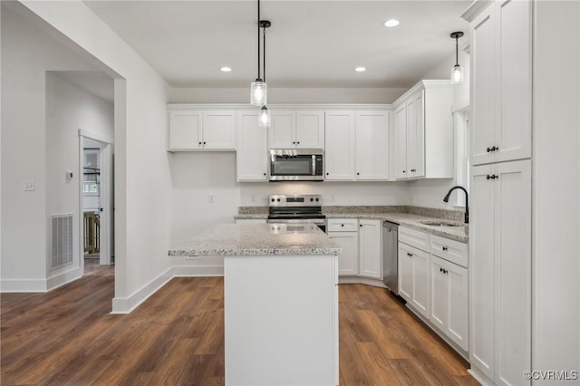 kitchen with stainless steel appliances, recessed lighting, white cabinets, and a sink