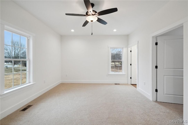 empty room featuring baseboards, light carpet, recessed lighting, a ceiling fan, and visible vents