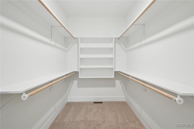 spacious closet with visible vents and carpet