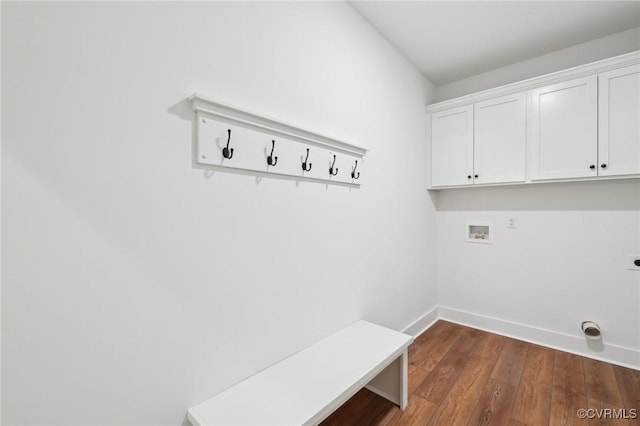 washroom featuring electric dryer hookup, baseboards, dark wood-style floors, washer hookup, and cabinet space