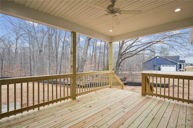 deck featuring ceiling fan and an outdoor structure