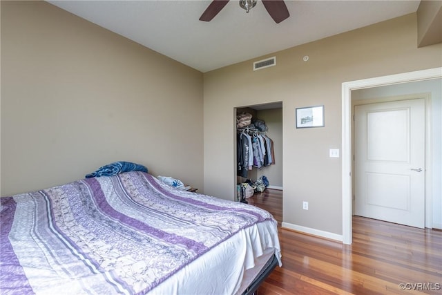1101 Haxall Pt Unit U810, Richmond, VA 23219 - bedroom with wood finished floors, a ceiling fan, a walk in closet, and a closet