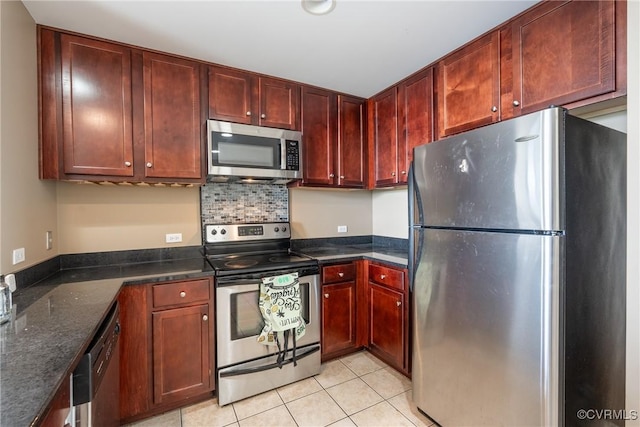 1101 Haxall Pt Unit U810, Richmond, VA 23219 - kitchen with stainless steel appliances, light tile patterned floors, reddish brown cabinets, dark stone countertops, and backsplash