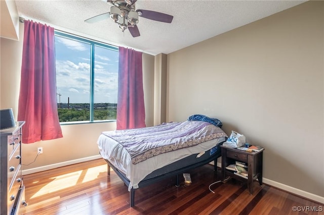 1101 Haxall Pt Unit U810, Richmond, VA 23219 - bedroom featuring wood finished floors, a textured ceiling, and a ceiling fan