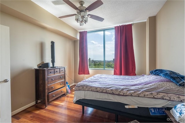 1101 Haxall Pt Unit U810, Richmond, VA 23219 - bedroom featuring wood finished floors, ceiling fan, and a textured ceiling