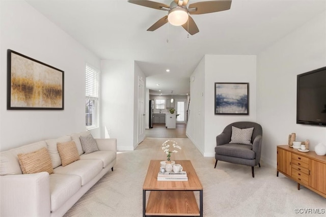 living room with recessed lighting, light colored carpet, and ceiling fan