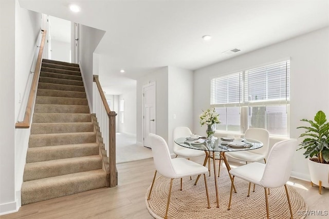 dining area with stairs, light wood finished floors, baseboards, visible vents, and recessed lighting