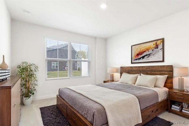 bedroom featuring baseboards and light colored carpet