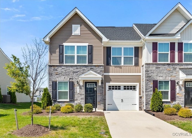 view of front of house featuring driveway, stone siding, board and batten siding, an attached garage, and a front yard