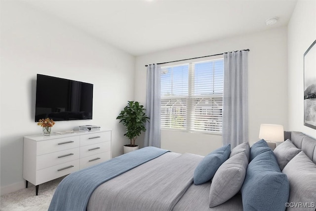 bedroom featuring light colored carpet