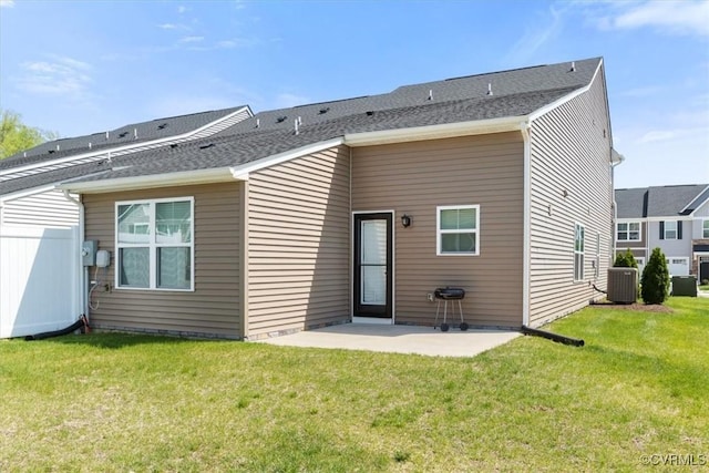 back of house featuring central AC unit, a yard, and a patio