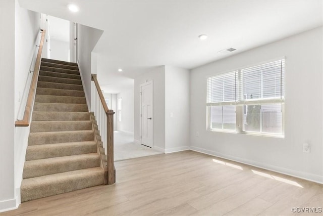 interior space with recessed lighting, wood finished floors, visible vents, and baseboards