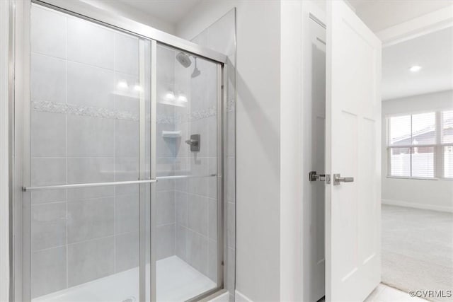 bathroom featuring recessed lighting, baseboards, and a stall shower