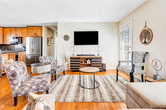 living room with recessed lighting and light wood-style floors