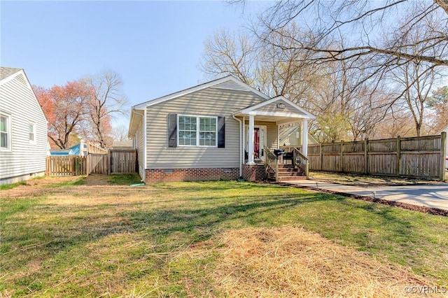 bungalow-style home with a porch, crawl space, a front lawn, and fence private yard